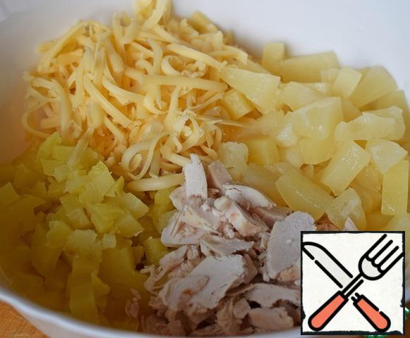 Ready chicken fillet and potatoes cut into pieces. Grate cheese, add pineapple pieces (cut if necessary).