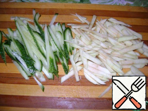 Fresh cucumber and peeled Apple cut into strips.