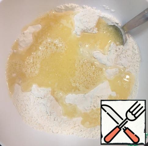 Pour the egg and water into the flour mixture and mix.