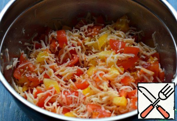 Bulgarian pepper and tomato cut into small cubes. Garlic skip through the press. (garlic optional) grate Cheese on a fine grater and half of the cheese and add to vegetables. Stir, add a little salt if necessary.