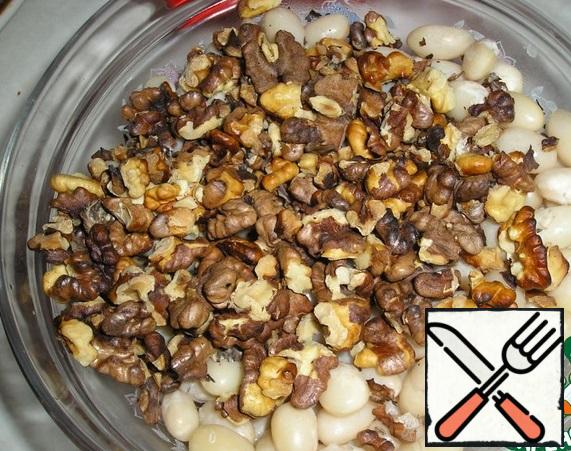 Fry the nuts in a dry pan and add to the beans.