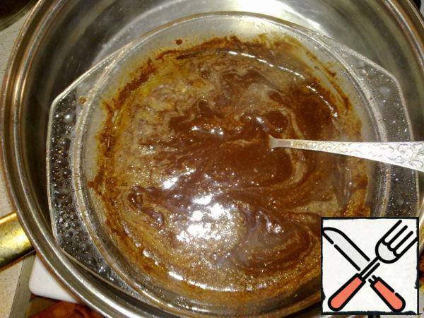 Break the chocolate into pieces, add butter to it and put it in a water bath until completely dissolved.
