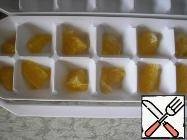 The pulp of half an orange cut into small pieces and put into molds for ice.