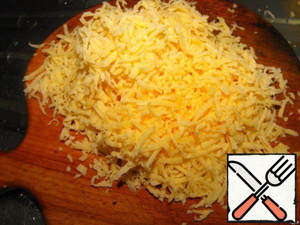 Grate the cheese on a fine grater.
