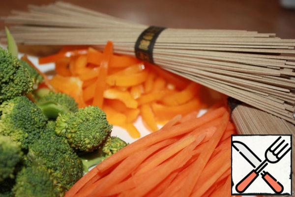 While the meat is marinating, prepare the vegetables. Cut the carrots into strips. Pepper and broccoli strips.
