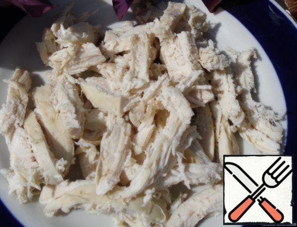 Boil chicken fillet and cut into strips.