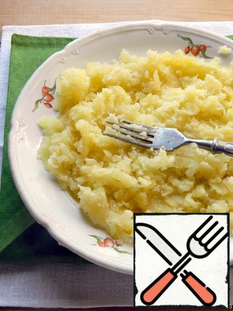 Boiled potatoes mash with a fork.