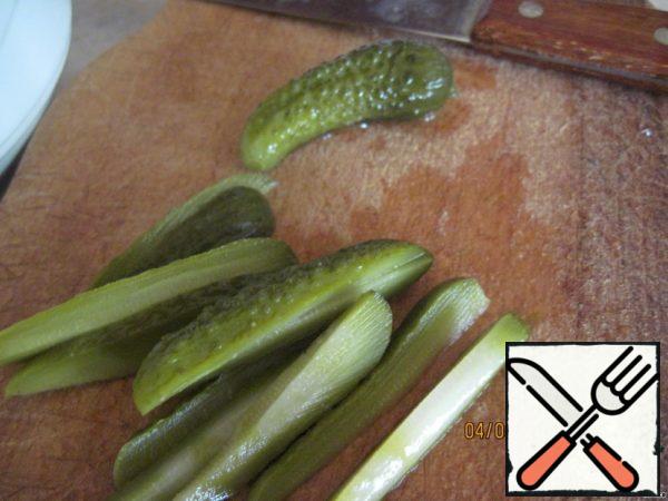 Cucumbers cut into thin strips, I took pickled gherkins, and in the restaurant were salted, cut into half rings.