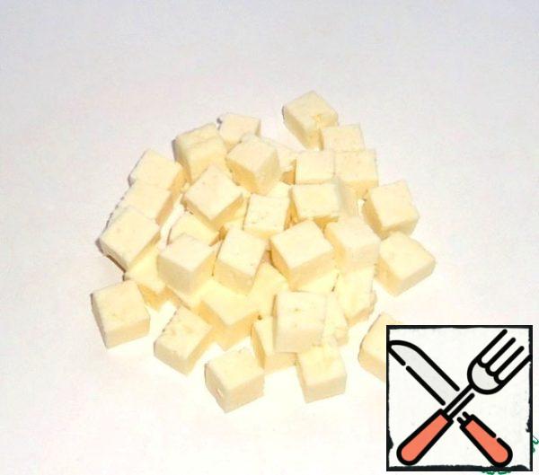 Cut the cheese into cubes.
