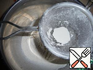 In flour, add salt, baking powder and sift into a bowl.