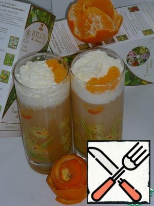 Decorate with whipped cream and a slice of tangerine.