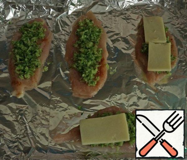 Turn on the oven so that it warms up to 200 degrees.
Then we spread layers on a baking sheet lined with paper or foil: chicken, broccoli, cheese.