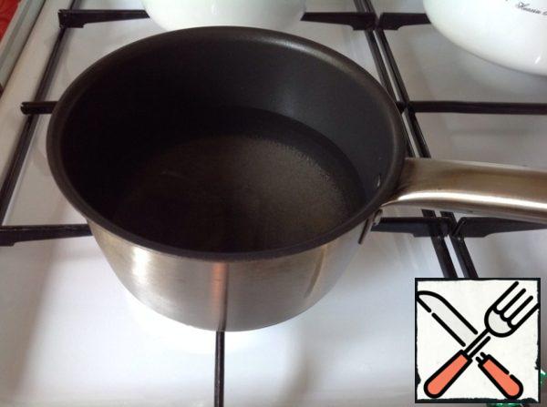 Dissolve the sugar in water and bring to a boil.