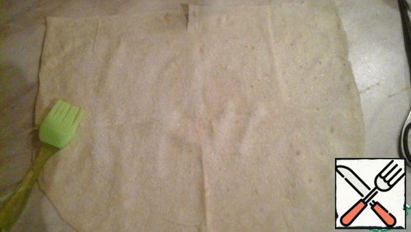 Brush the pita bread folded in half with vegetable oil and sprinkle with sugar.
