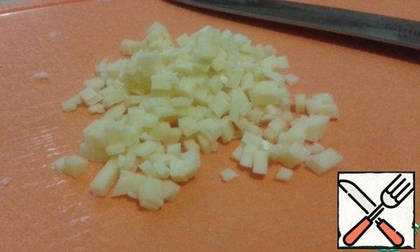 Cut the cheese into small cubes.