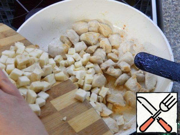 While the chicken is frying, chop the celery. We send it to the fried meat. Mix it.
