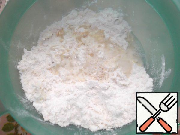 Gradually add warm (not hot) water. Knead the dough.

