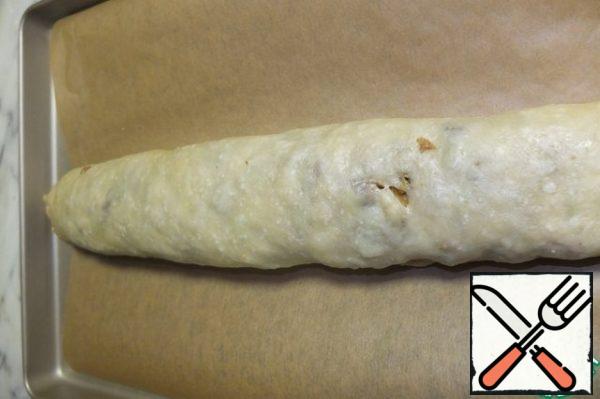 Roll the strudel into a tight roll. If your filling has not cooled down yet (like mine), you need to do it quickly before the thin dough begins to spread.
Then place the strudel on a baking sheet lined with baking paper.