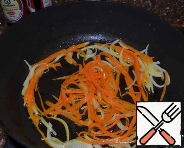 Fry carrots ( long thin straw) and onions (feathers) in vegetable oil.