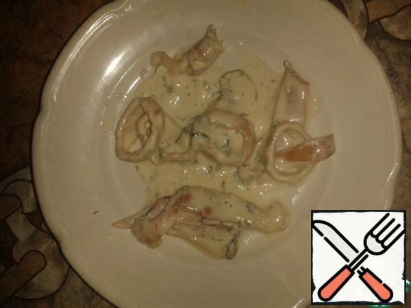 Simmer boiled squid with sour cream until thick, add spices, herbs and salt.