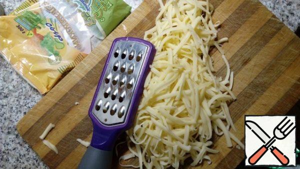 Cheese to grate on a large grater.
