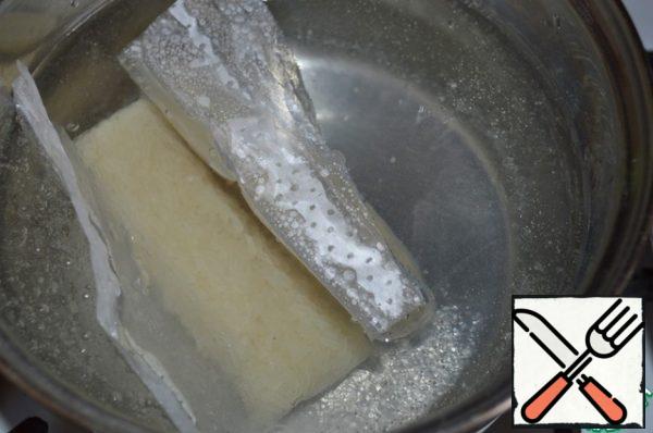 Put a pack of rice in boiled water.
