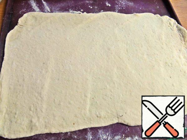 Roll out into a rectangular layer.
