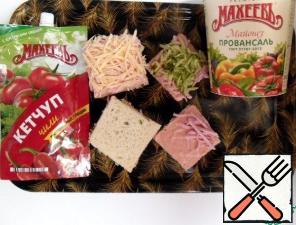 Mix mayonnaise with ketchup.
Spread each layer of bread with the resulting sauce.
Put the sausage on the bottom, then the cucumber, lightly tamping.
cover with a new layer of bread. Sprinkle sausage and cheese on top.
If you need to serve sandwiches, carefully tamp the top, sprinkle with coconut shavings.
Coconut chips, like all nuts, gives the dish a taste, makes it unique.