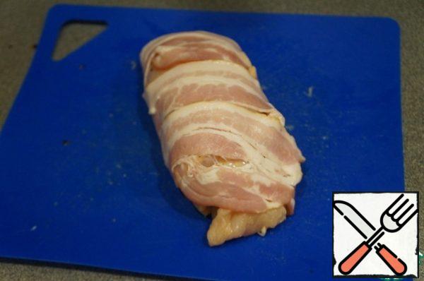 Wrap the stuffing inside. Wrap two strips of bacon.