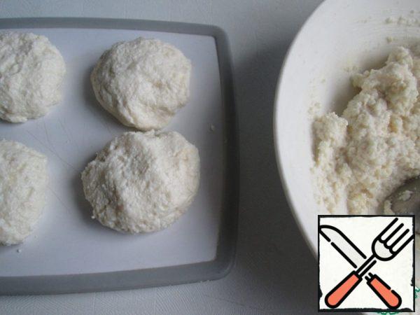 Then form the cheesecakes: take a tablespoon of dough, roll it out in your hands and mash it a little. If the mass is soft and does not hold its shape, then add flour to the dough and mix well. I added
1 tbsp flour, that was enough.