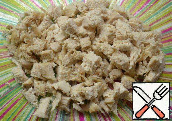 Boil the chicken in salted water. Cut into cubes.
