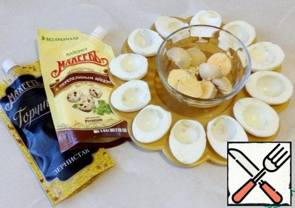 Boil the eggs, cut them in half lengthwise and remove the yolks.
