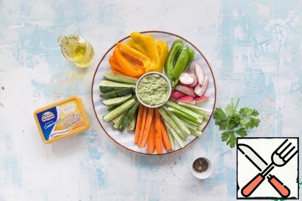 Place the bowl with the sauce in the center of the dish. Arrange the vegetables around the colored sectors. Serve immediately.