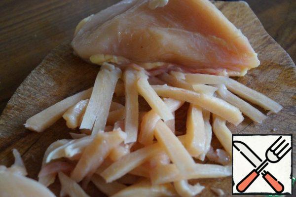 Cut the chicken breast into strips.