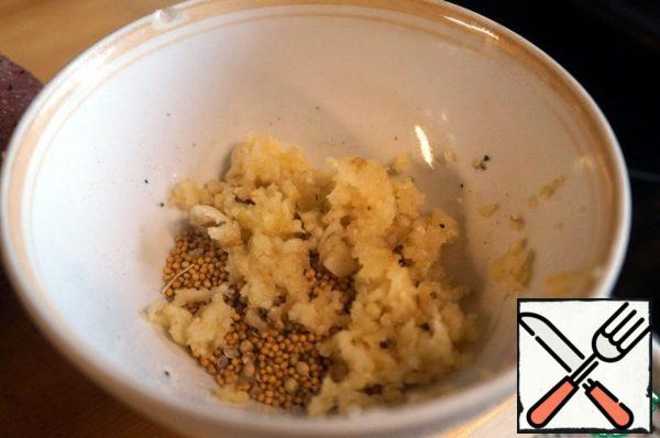 Add crushed garlic, coriander seeds and mustard to the remaining mixture of salt and pepper.