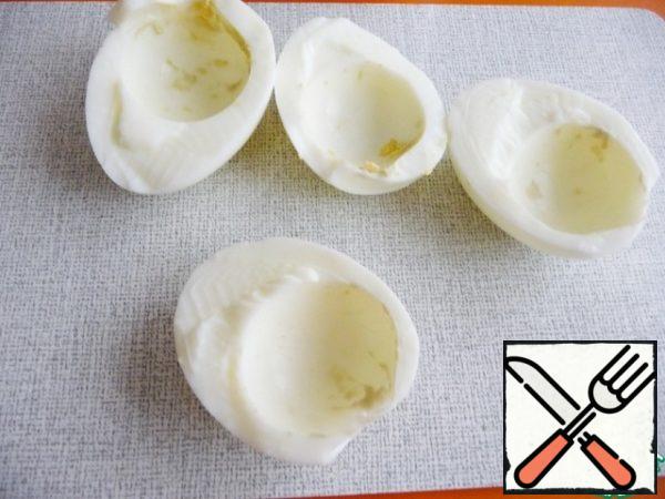 Boil eggs hard and cool. Eggs to clear, cut in half and to remove the yolk.