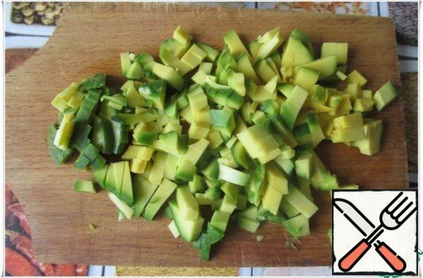 Peel the avocado, remove the stone and cut into small cubes, sprinkle with a small amount of lemon juice.
