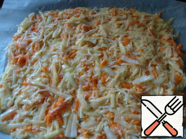 Preheat the oven to 180 degrees. Cover the baking sheet with paper, and put the vegetable mixture on top not very thickly.
