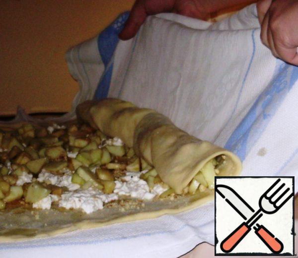 Roll the strudel with a towel.