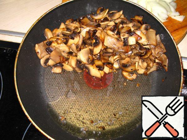 Drain the excess oil from the fried mushrooms, turning the pan on its side, then carefully spoon the mushrooms into a salad bowl.
