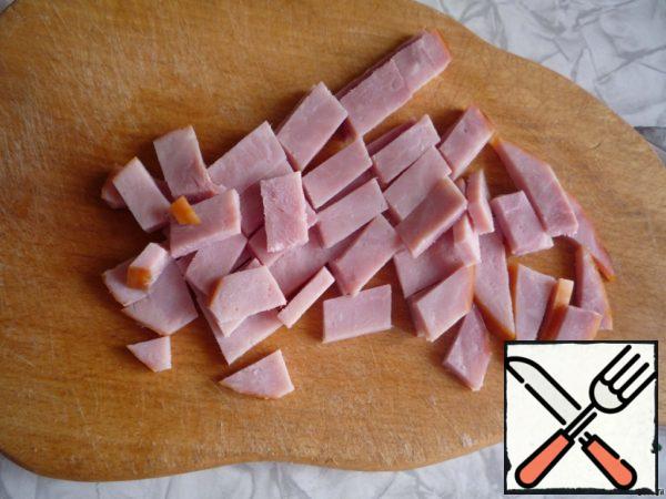 Cut into slices ham.