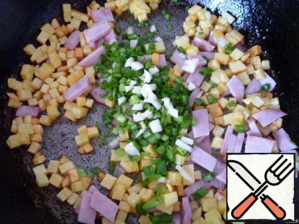 Here we also add finely chopped onion and garlic. Fry for another 2 minutes on low heat. Then pour everything into a bowl and let cool slightly.
