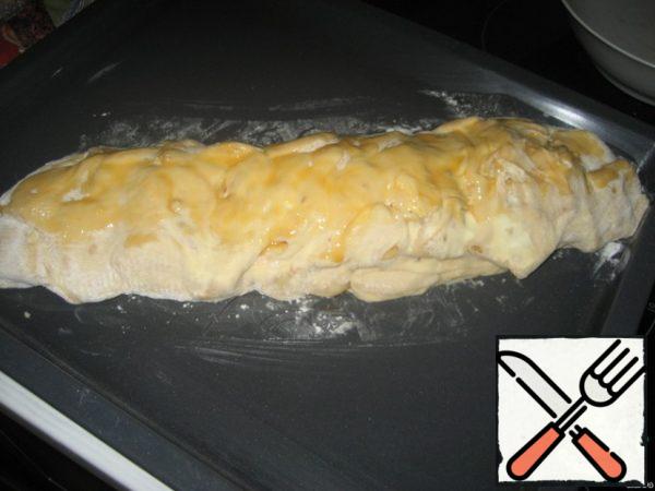 Put the roll on a baking sheet seam down. Beat milk with egg yolk and brush on top of loaf. Put in the oven for 35 minutes at 220.
Bon appetit!