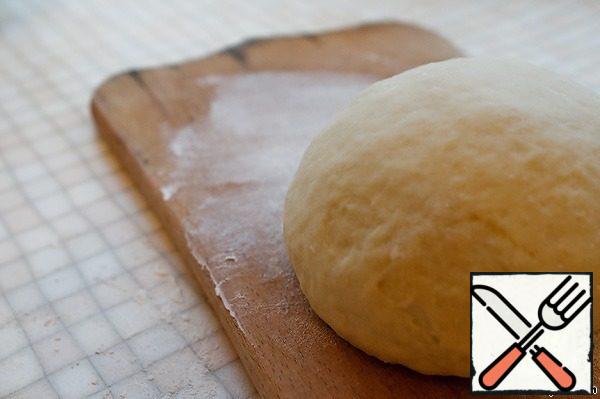 Mix flour, salt, sugar and baking powder, add olive oil. Gradually add water. Knead the soft, not sticky dough.
Cover with a towel and leave the dough for 15-20 minutes.