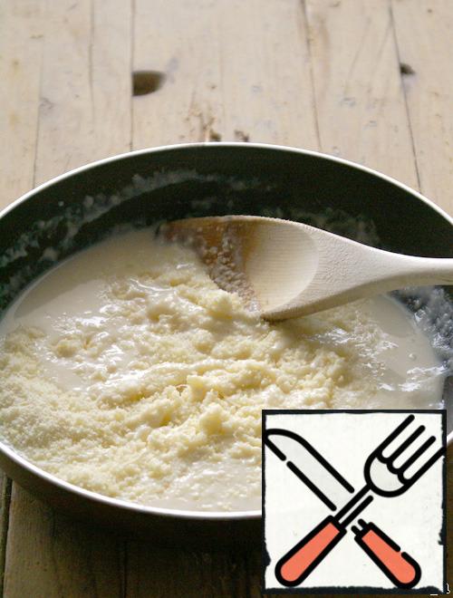 Melt butter. Brown the flour. Gradually pour the milk, stirring with a wooden spoon. Cook the sauce for about 1 - 2 minutes, stirring constantly. Add grated cheese or Parmesan. Salt and pepper to taste.