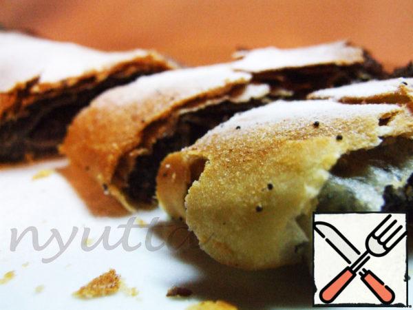 Remove the baked strudel from the oven and cool it a little, and at this time prepare berry sauce: dilute the cherry jam with water and bring to a boil, dilute the starch in a small amount of cold water and pour into boiling cherry syrup (in fact, it turns out thick jelly).
Sprinkle the strudel with powdered sugar, cut into portions. Pour berry sauce on a plate, spread a portion of strudel and invite your loved ones to drink tea with delicious strudel!