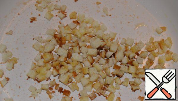 Crumbs of white bread fry in a small amount of butter.