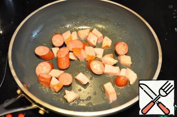 Fry bacon and sausages. Then, in a dry pan, brown the sesame seeds.