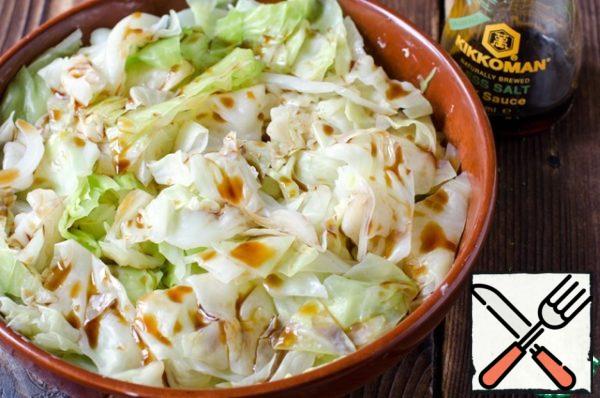 Boil the cabbage in salted boiling water for about 5 minutes.
Flip it into a colander and let the excess water drain.
Put the cabbage in a greased heat-resistant form. Pour in 3 tablespoons of soy sauce.