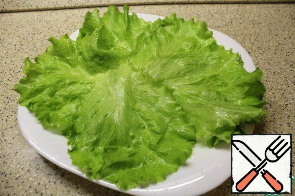 On a dish lay out lettuce leaves.